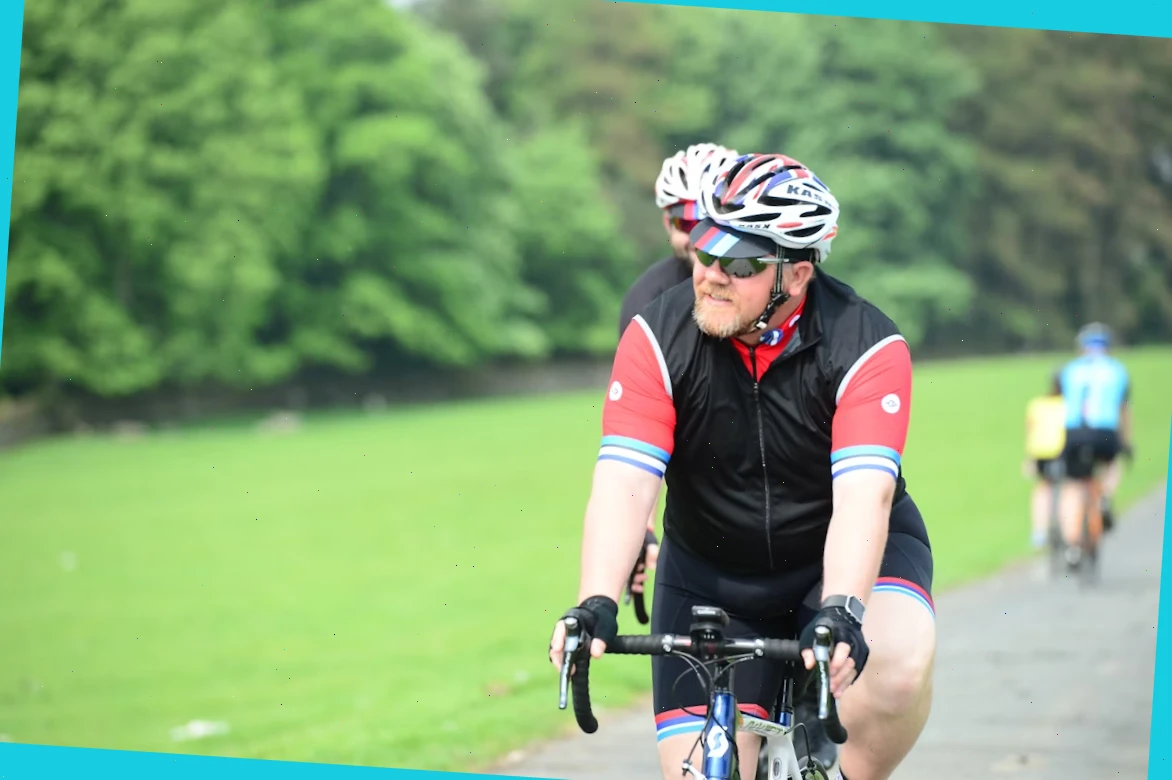 Safety rider checking helmet straps before a cycle tour